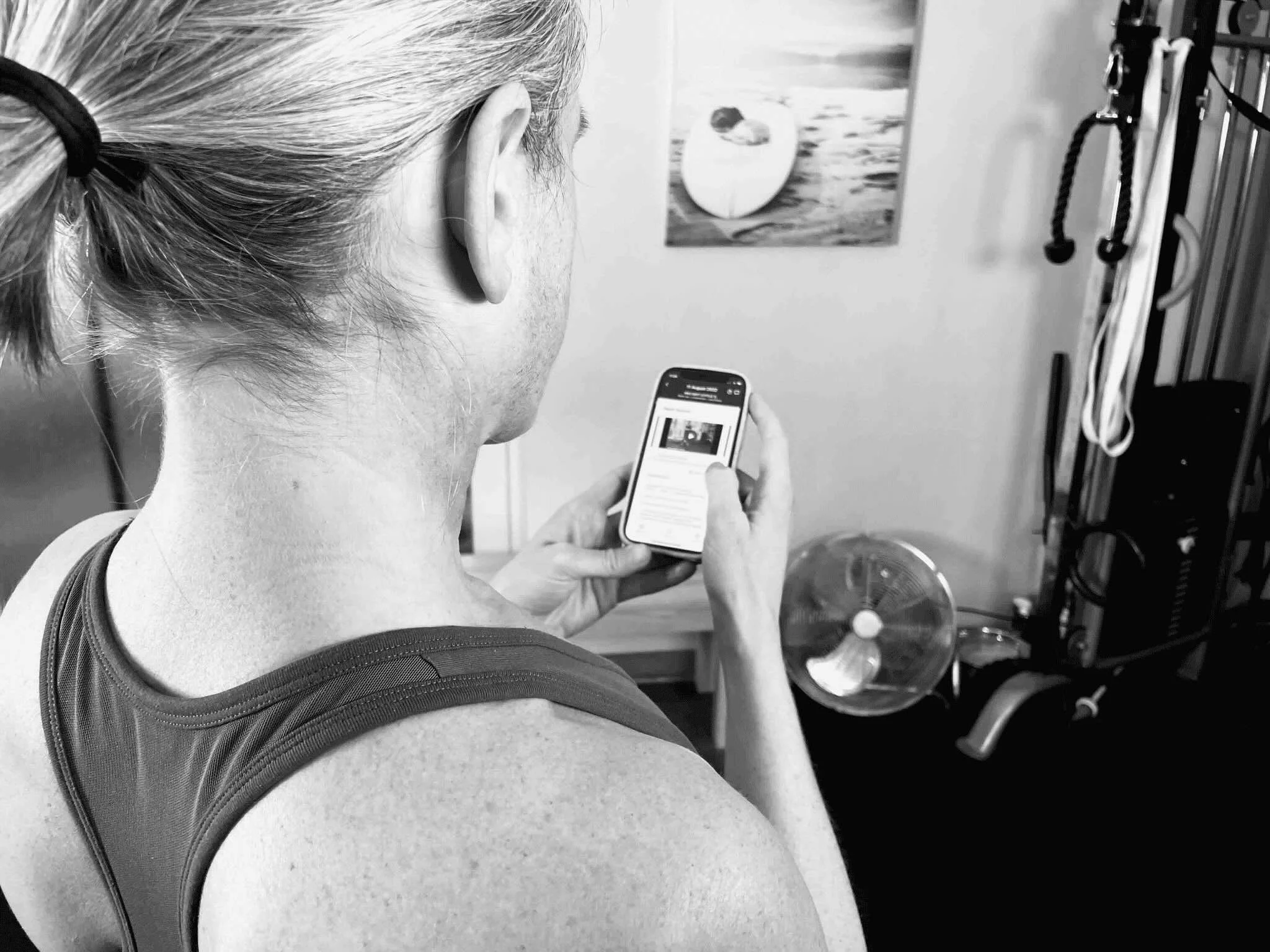 a woman over 40 at home about to do a strength workout in an app