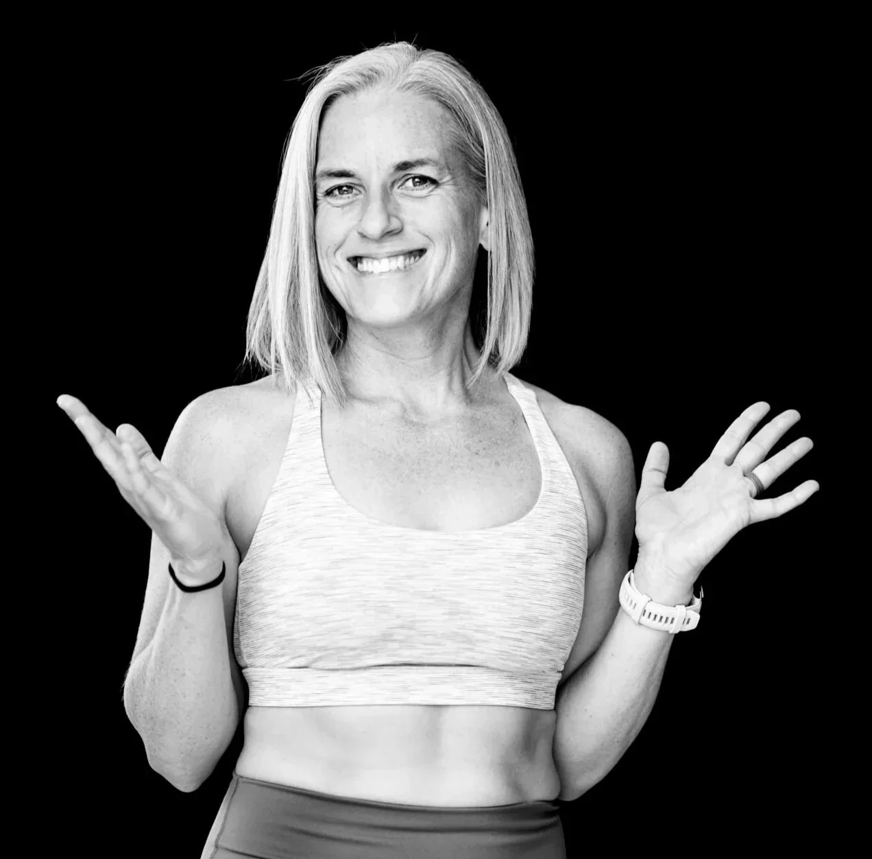 A woman smiling with arms open portraying a welcoming gesture wanting you to improve your mobility