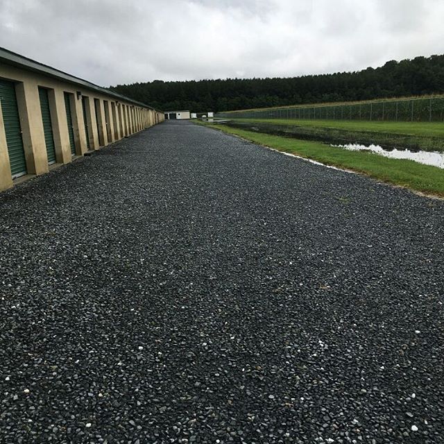 As always, we're high & dry! The power of a well designed and properly graded site keeps water away from the buildings, funneling it down the center of the roadways and into the storm water management pond. π