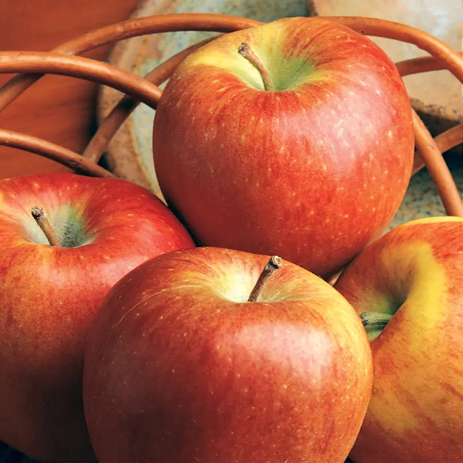 Braeburn apples with orange-red skin in a basket