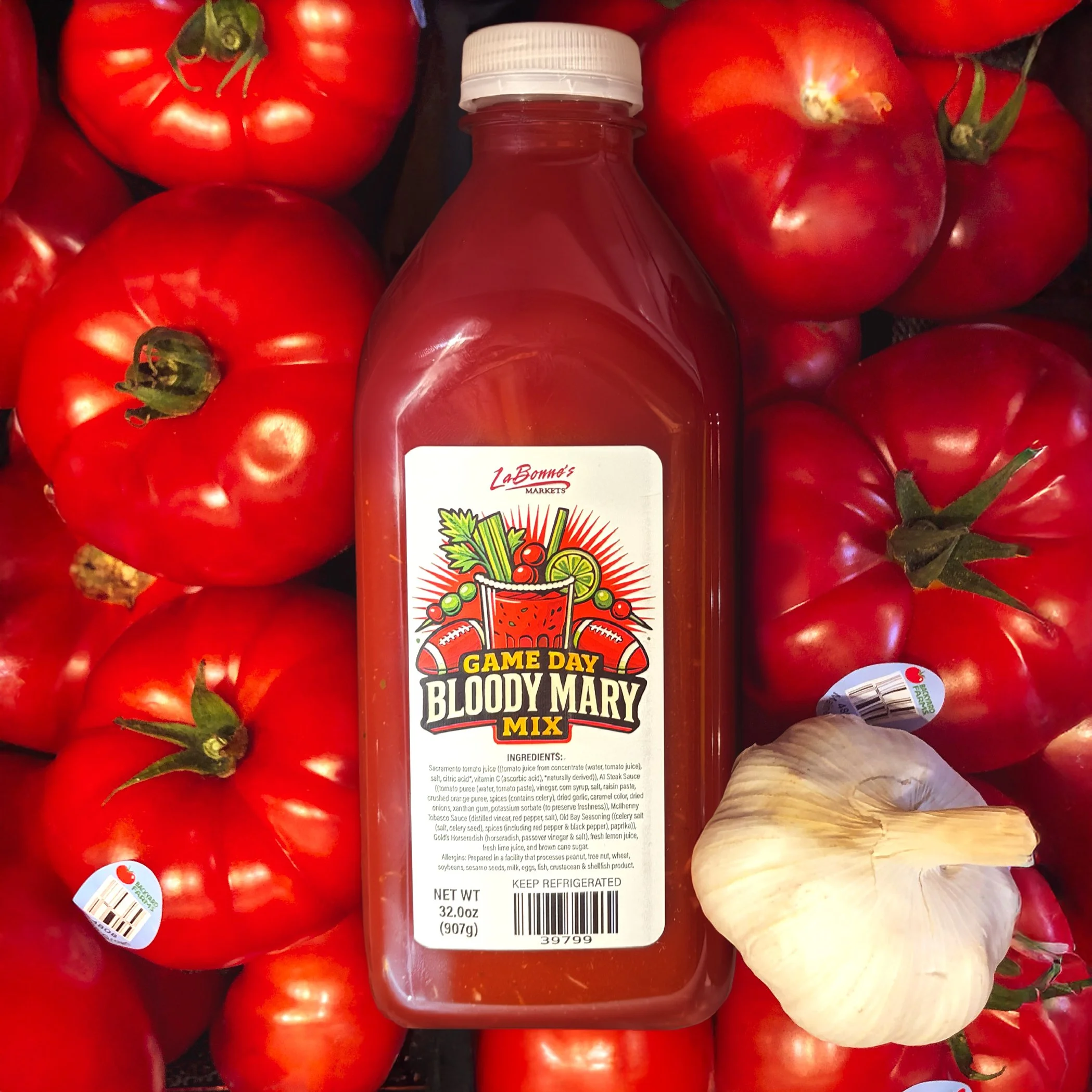 Game Day Bloody Mary Mix with a garlic clove over tomatoes.