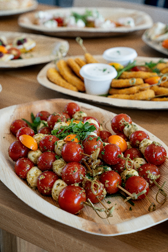 Caprese skewers with tomatoes, mozzarella, and herbs on a serving tray