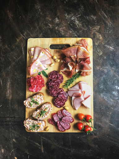 Charcuterie board with cured meats, cheeses, fruit, and crackers