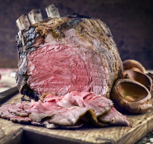 Medium-rare bone-in rib roast showing pink center and seasoned crust