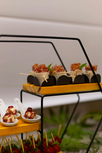Mini plated appetizers displayed on tiered stands for catering