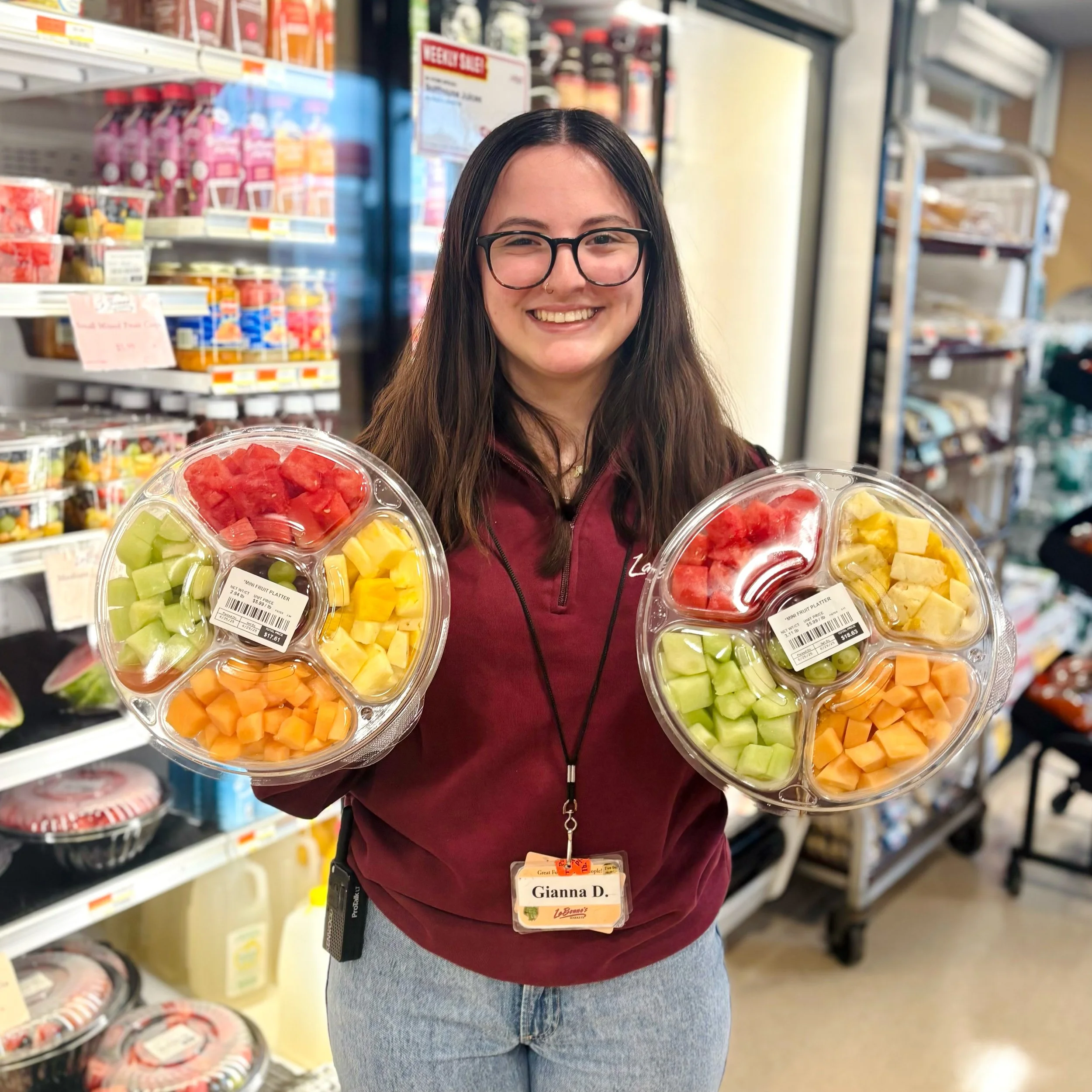 Watertown employee holding fruit platters