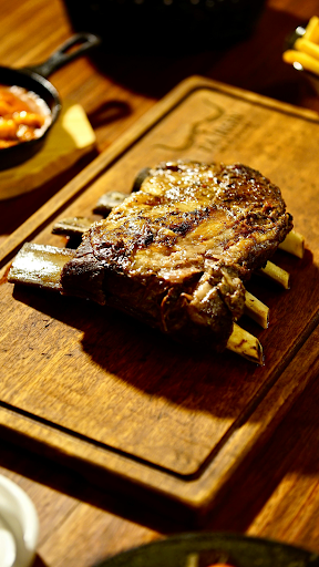 Thick slice of prime rib served on a plate with a browned crust
