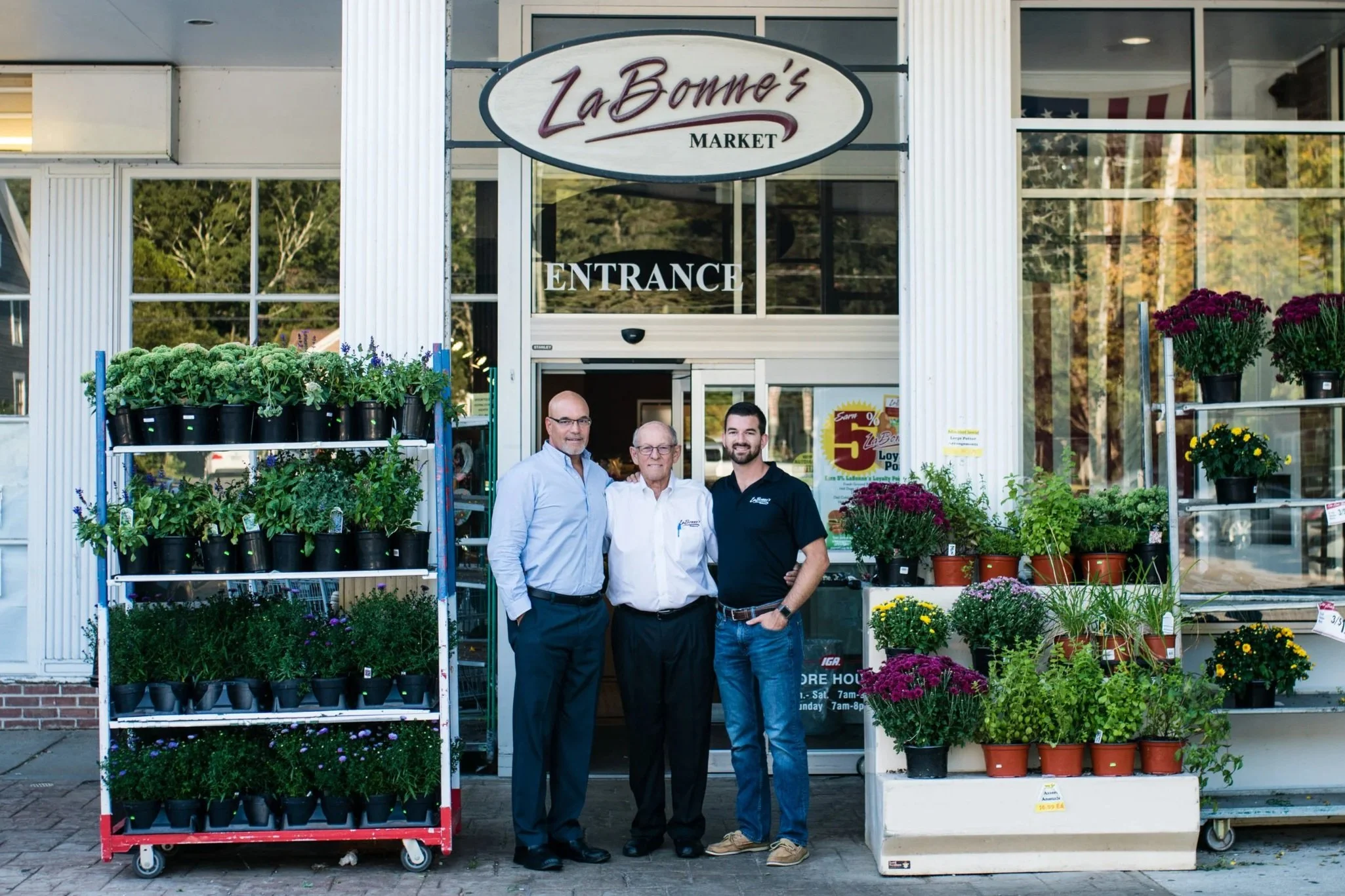 Bob Sr, Bob Jr, and Rob LaBonne in front of Woodbury store entrance