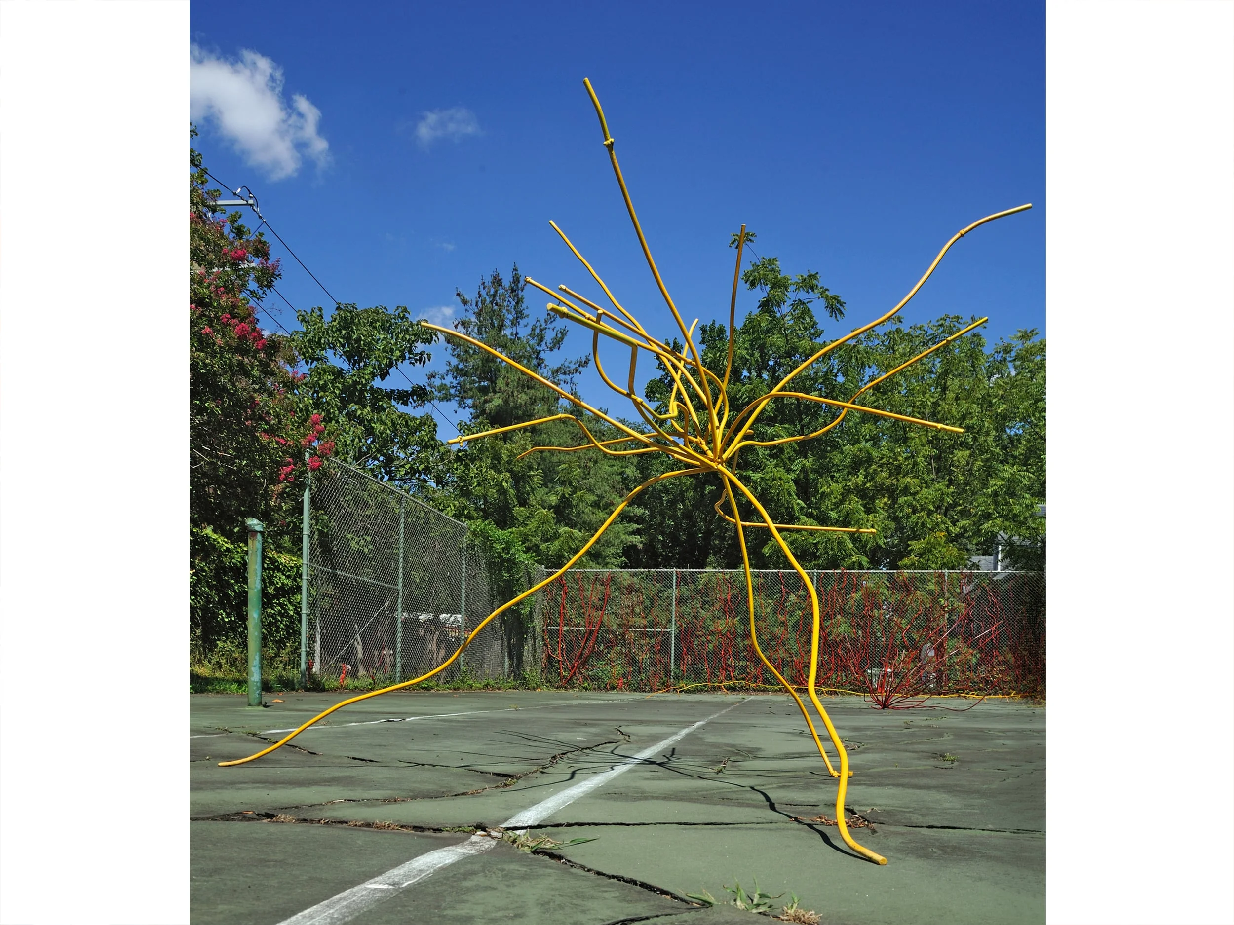 A small metal yellow ROOT sculpture on the cracked floor