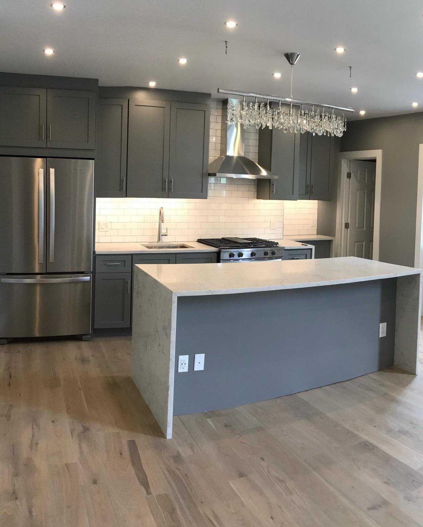 ACR Pro Contractors designed, built and relocated this Williamsburg, Brooklyn Kitchen featuring Dark Gray Shaker Cabinetry, a Quartz Countertop with Waterfall sides, LED lighting, Under Cabinet Lighting, a Subway Tiled Backsplash, an affordable Pantr