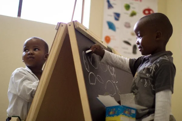  Toddlers in Ubuntu's Early Childhood Development program learn shapes and letters through art. 