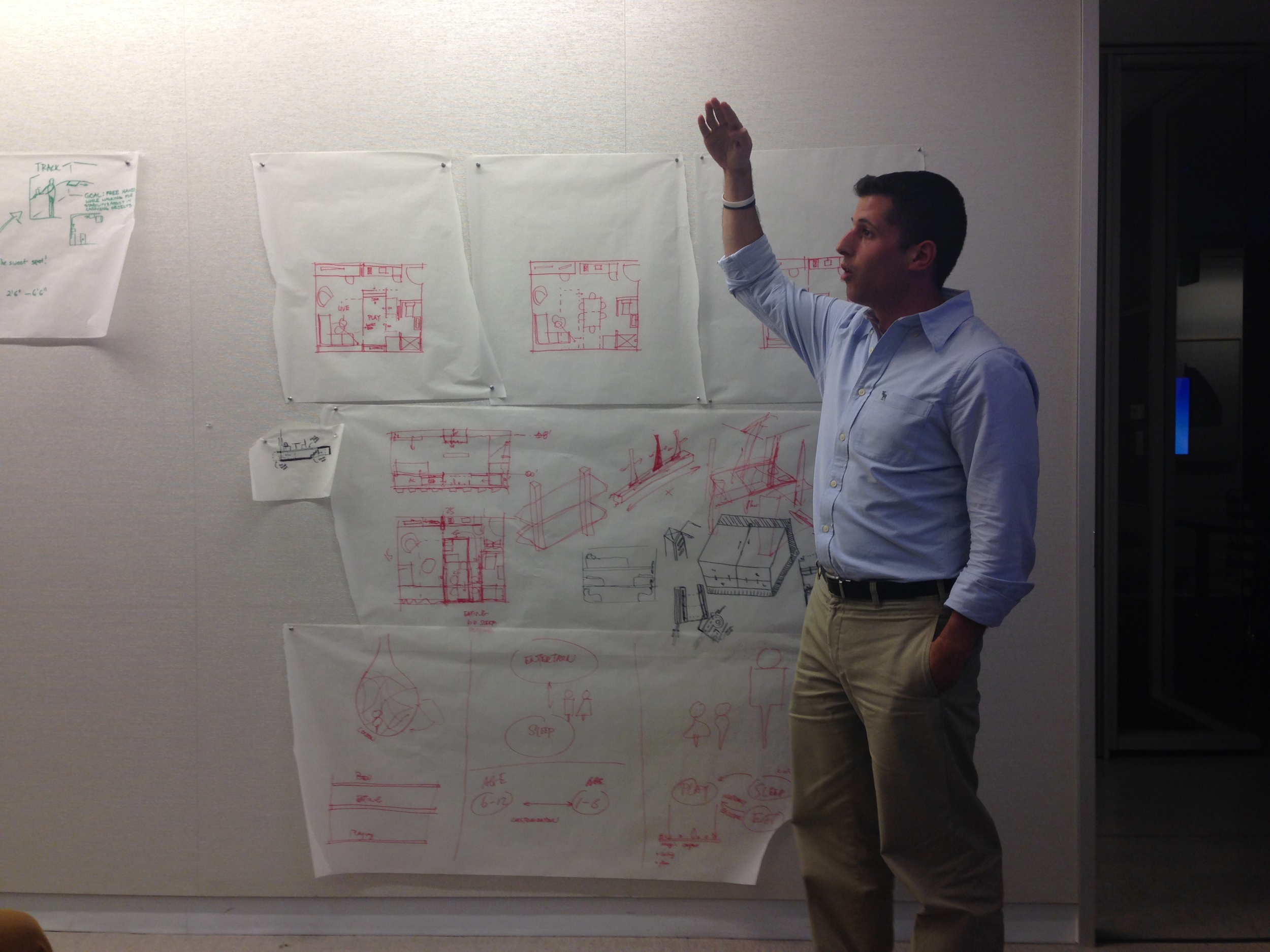Chris Bonarrigo explaining his team's vision of how to utilize the movable tools in micro housing design for a family of four.