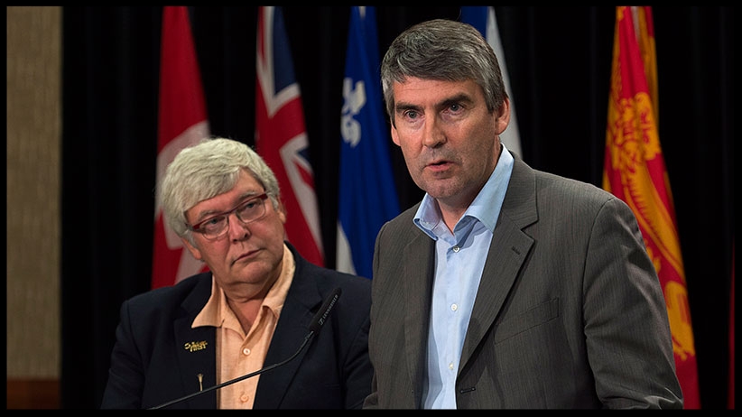 Nova Scotia Premier Stephen McNeil talks with reporters at the annual Council of the Federation meeting in Charlottetown in 2014 as then Alberta premier Dave Hancock looks on . (Andrew Vaughan/The Canadian Press)