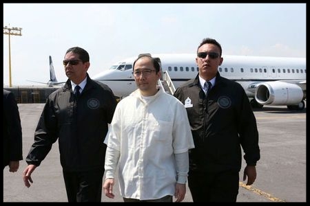 Zhenli Ye Gon, a businessman accused of working with drug cartels, is escorted by Interpol agents after arriving from the United States on a extradition flight in a hangar belonging to the office of the Attorney General in Mexico City, Mexico, October 18, 2016.