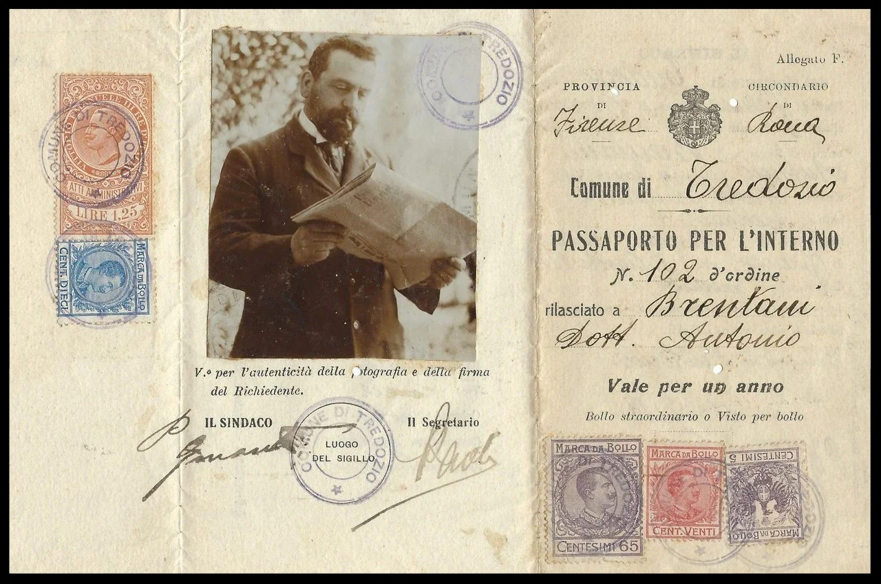 An 1918 Italian passport photo shows its bearer smoking a cigarette and reading a newspaper. 