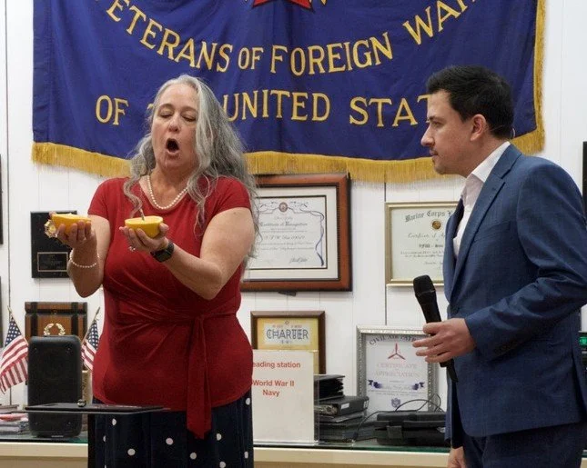 Audience member on stage reacting with wonder to Christopher Moro's stage magic show.