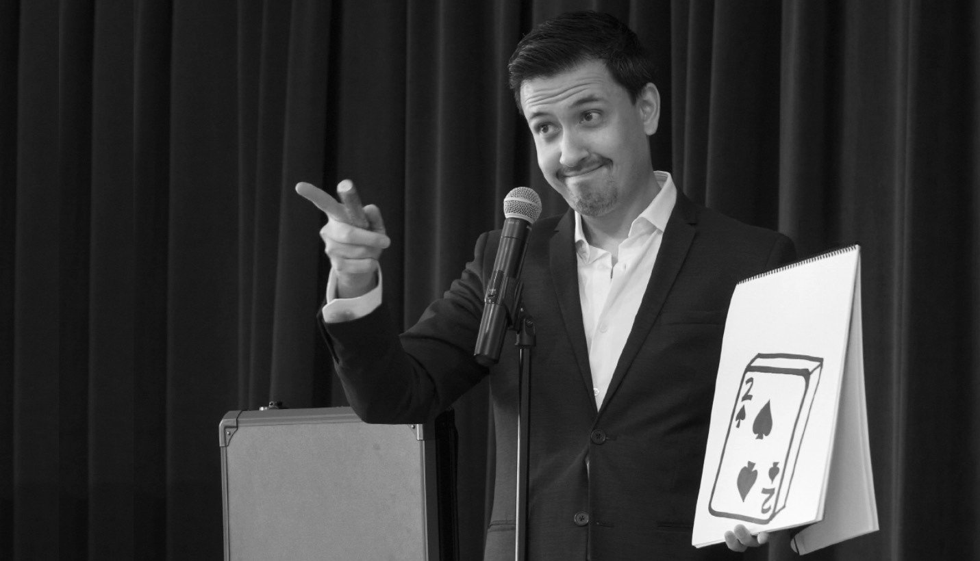 Christopher Moro performing stage magic with an oversized drawing pad