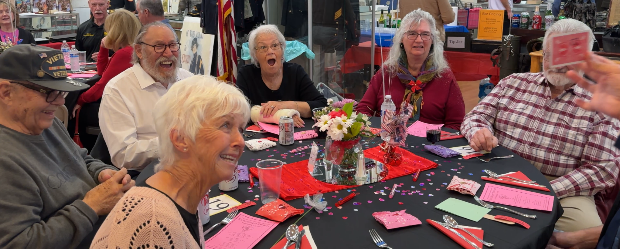 Candid audience reaction showing amazement during a live magic performance.