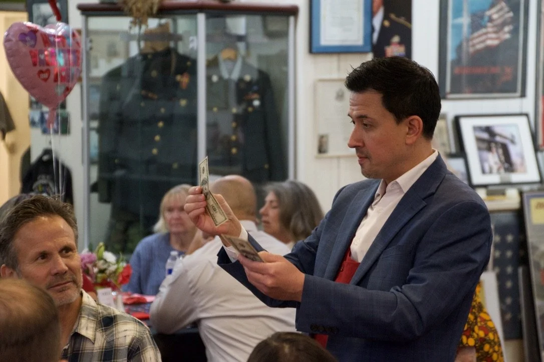 Candid moments of interactive magic performance at a private event.