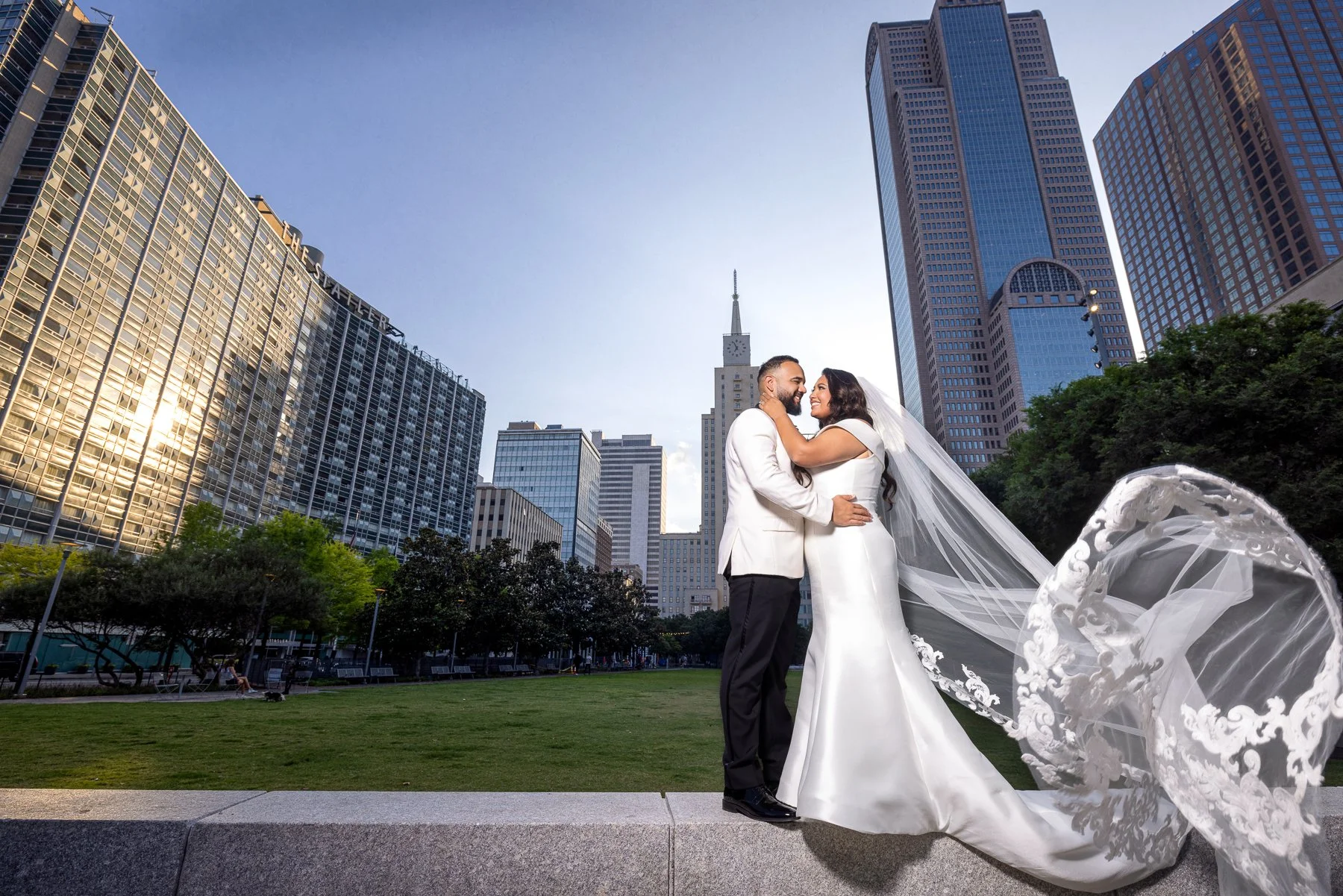 Creative bride and groom wedding portrait using the veil and Dallas architecture near The Hall on Dragon