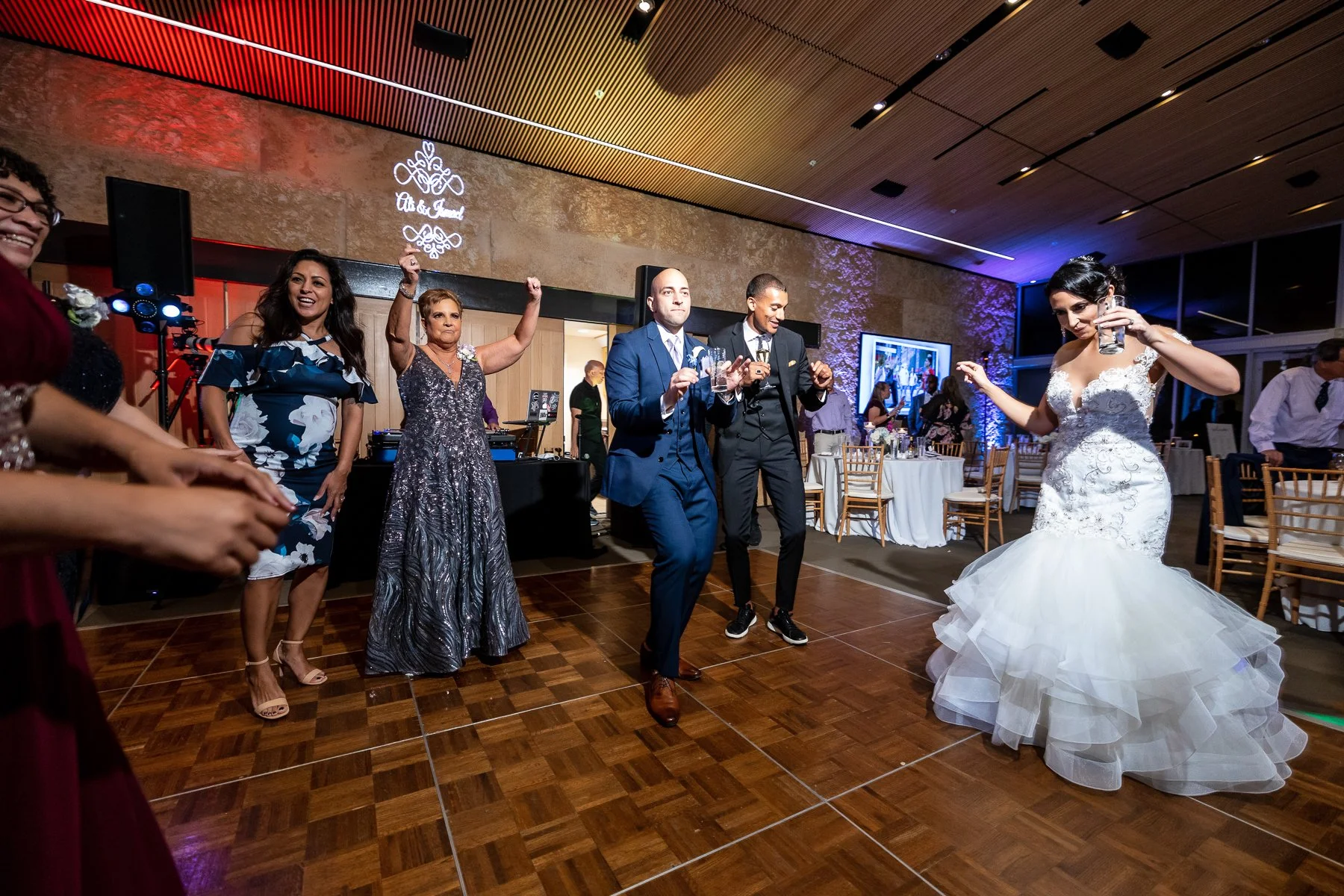 Bride dancing with guests during a Dallas Arboretum wedding reception in Dallas.