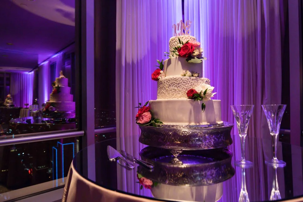 Wedding cake with floral decorations displayed inside Tower Club Dallas in Dallas, Texas.