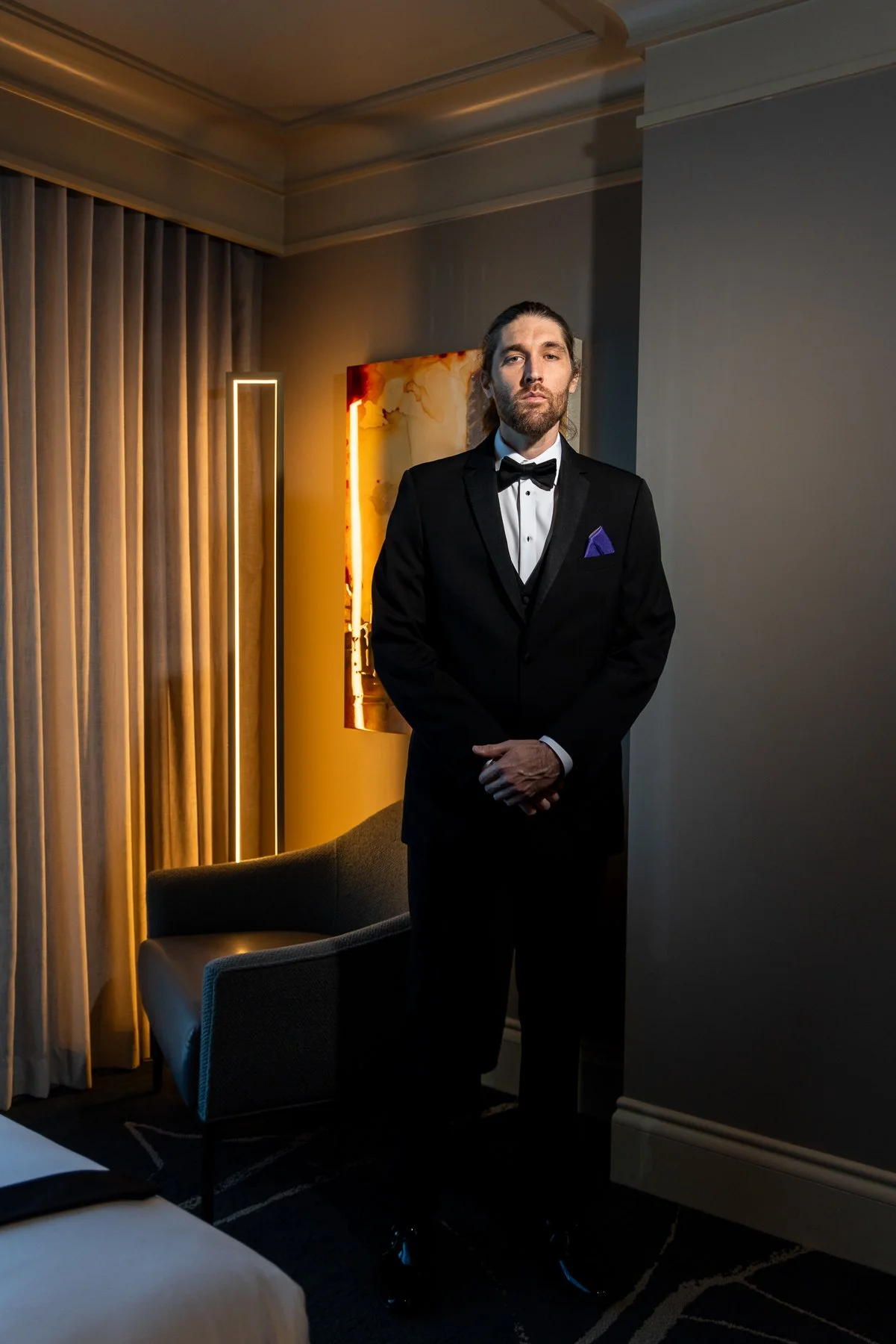 Groom in a black tuxedo during his wedding day at Omni Dallas Hotel in Dallas