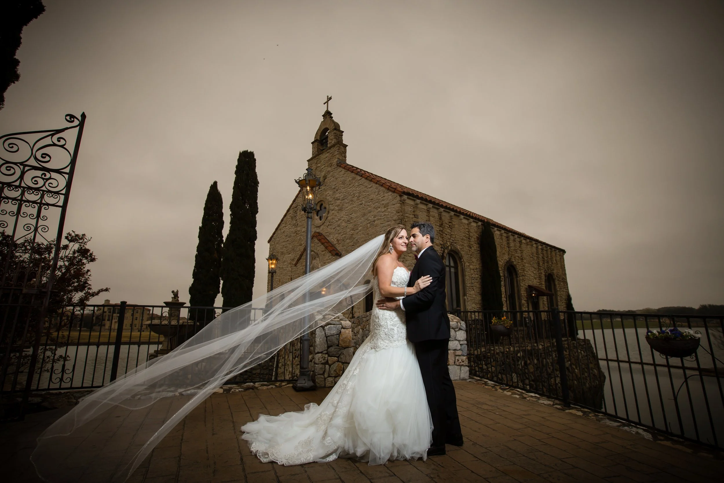 Bride and groom outside Bella Donna Chapel during their wedding in McKinney, Texas