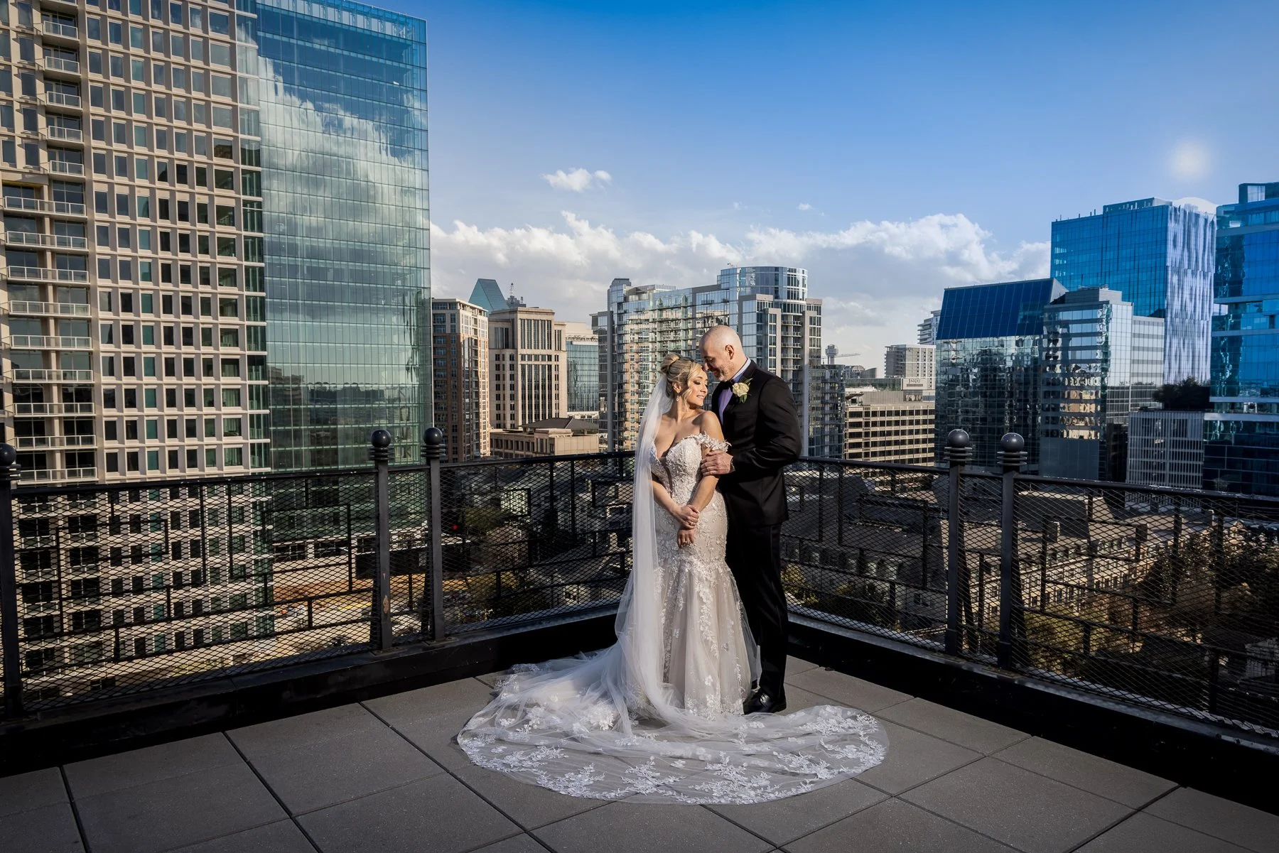 Bride and groom overlooking the Dallas skyline at The Stoneleigh hotel