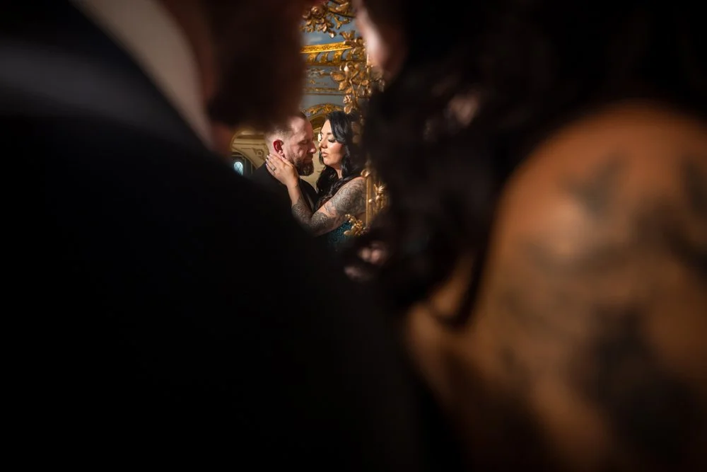 Couple’s close reflection framed by their out-of-focus figures in the foreground.