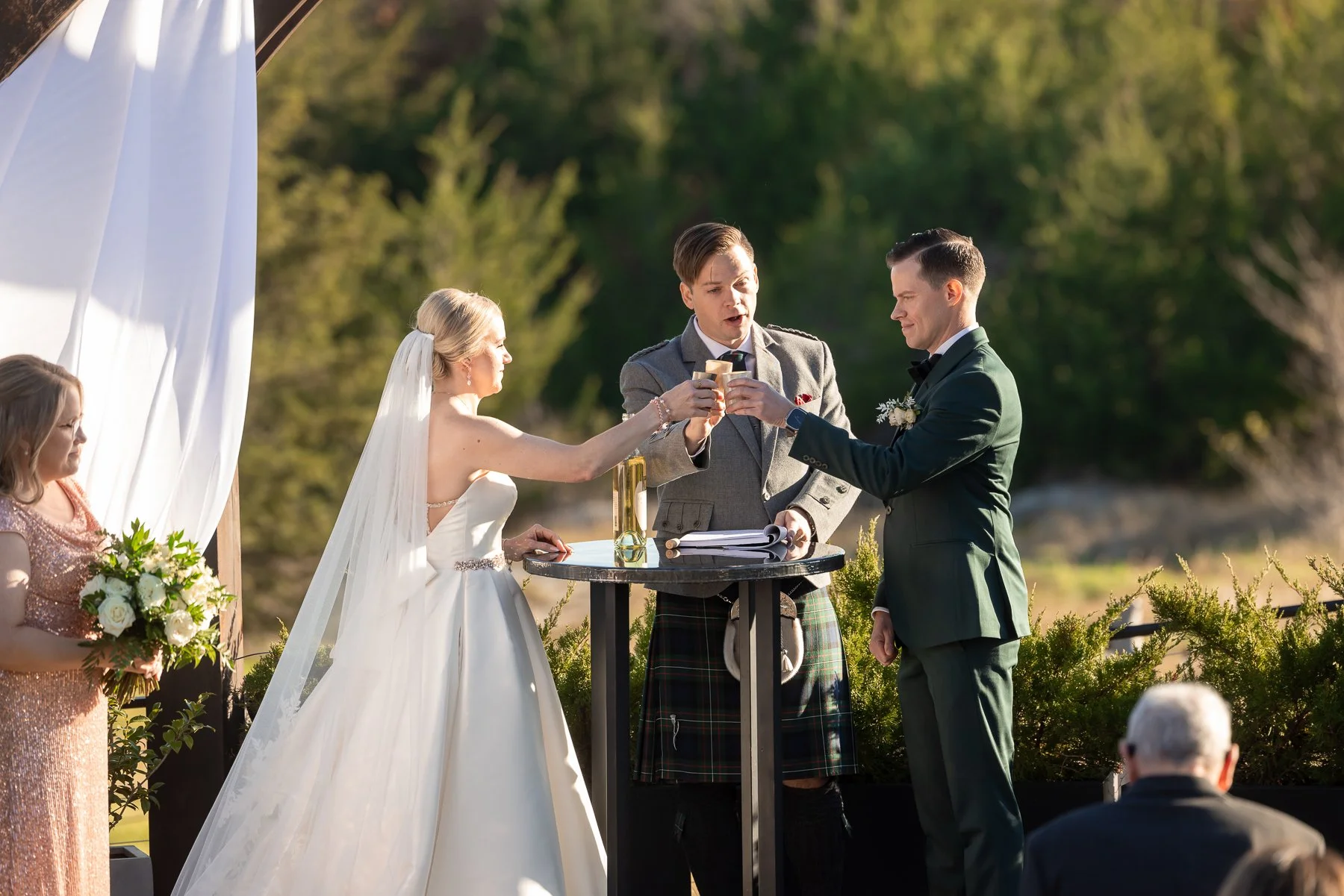 Bride and groom sharing a ceremony moment beneath the outdoor arbor at Stone Crest Venue near McKinney, TX.