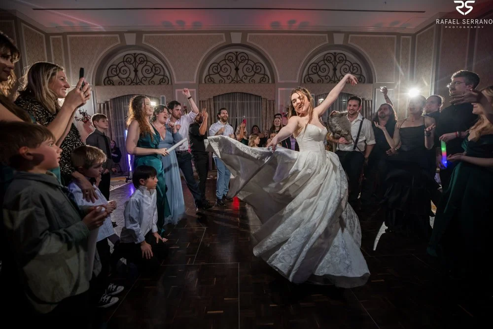 McKenna twirling with one arm raised while wedding guests celebrate around her.