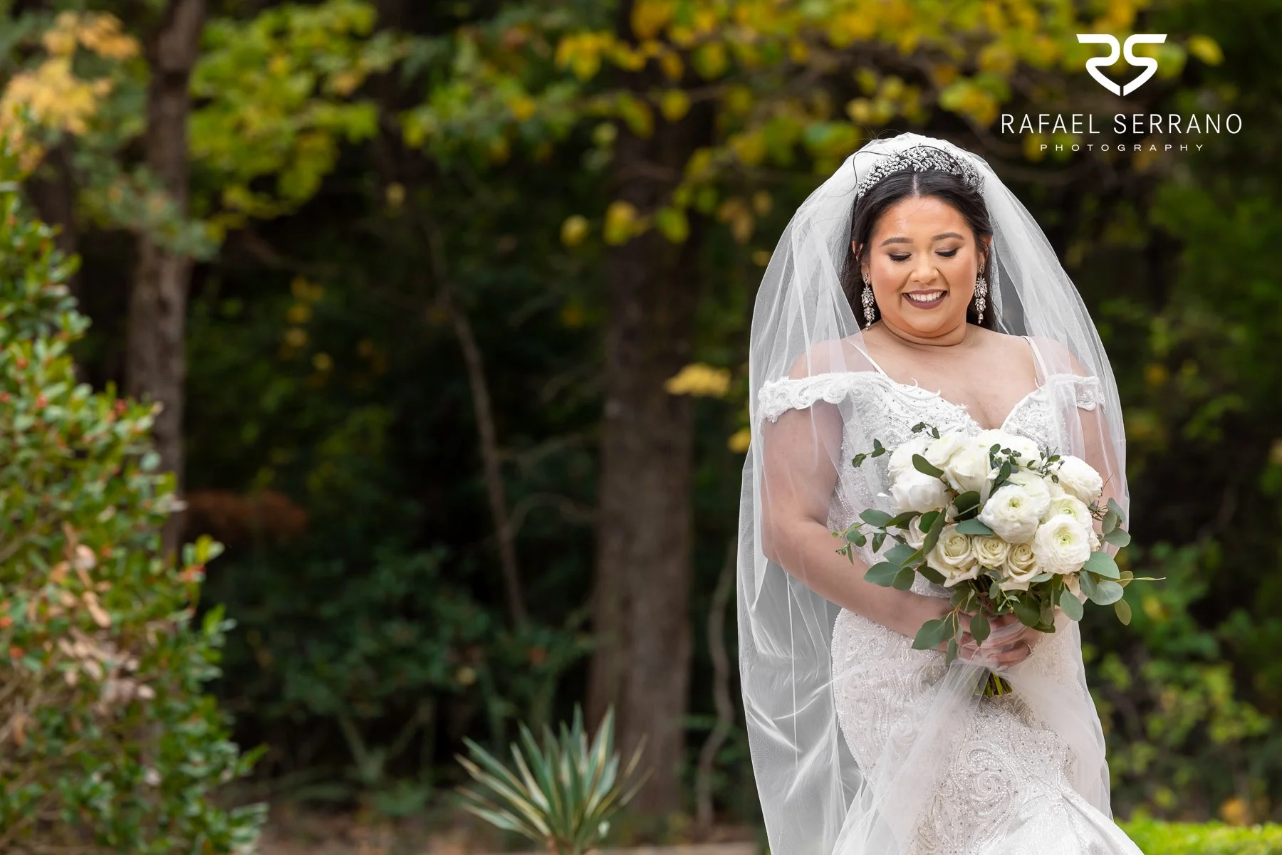 Bride holding a white and cream wedding bouquet.