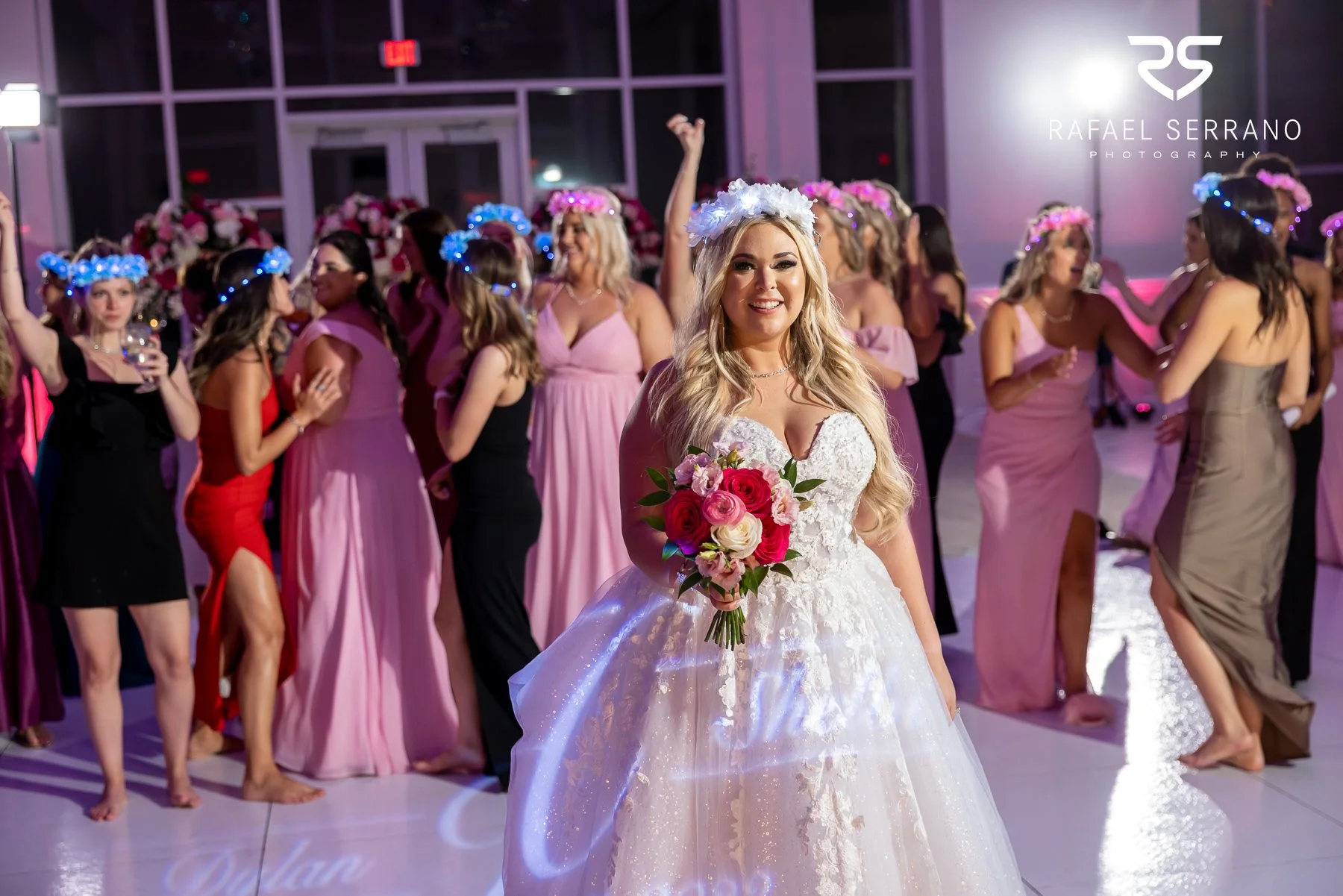 Bride holding a colorful red pink and white wedding bouquet.
