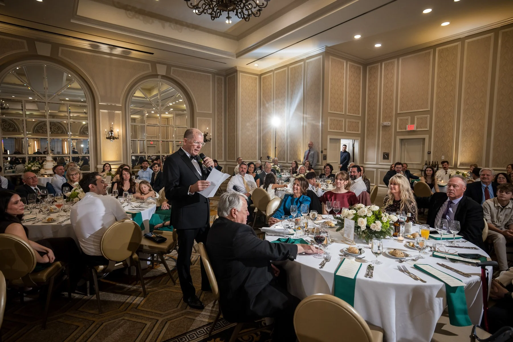 Wedding speech surrounded by guests during a reception at The Adolphus Hotel