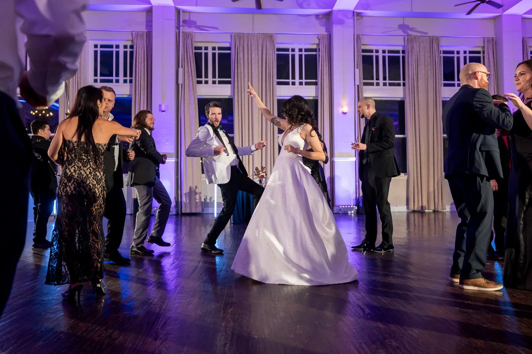 Wedding guests celebrating on the dance floor at The Room on Main wedding reception