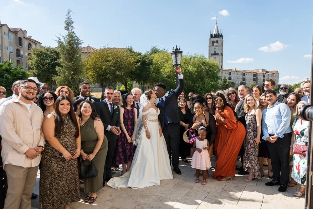 Large wedding group gathered outside Bella Donna Chapel with Mallory and Marcus.