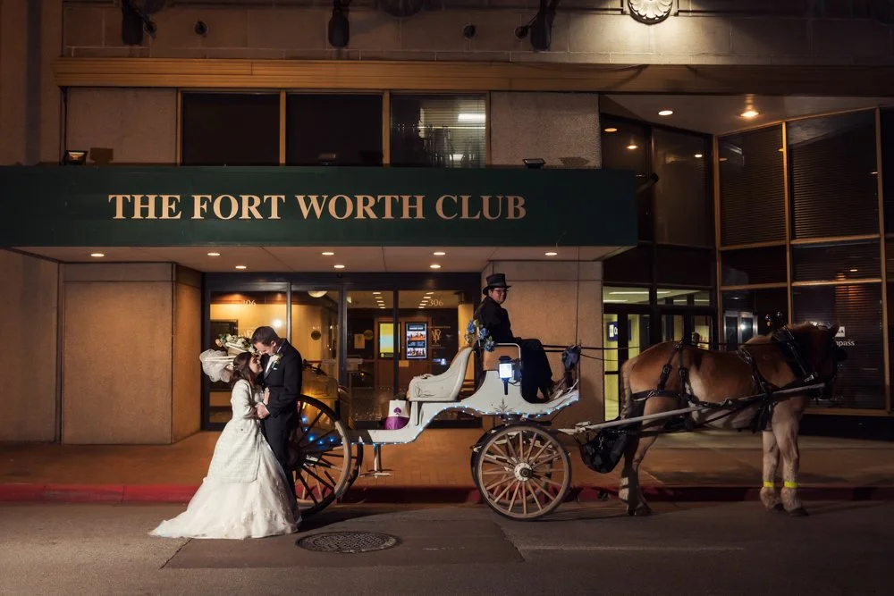 Bride and groom sharing a romantic wedding portrait inside The Fort Worth Club with elegant historic interiors and timeless architectural details.