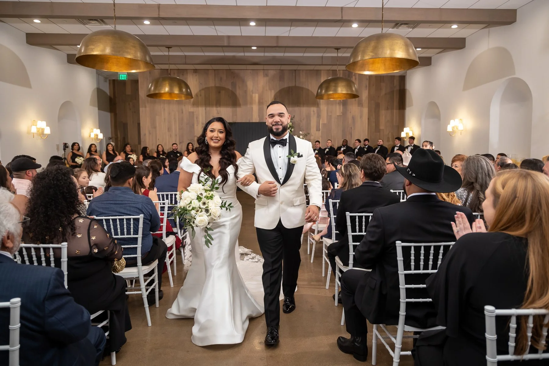 Bride and groom walking down the aisle after their wedding ceremony at The Hall on Dragon