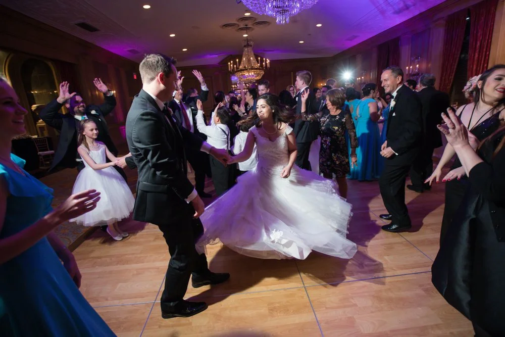 Wedding guests dancing during a reception at The Fort Worth Club with a lively celebration atmosphere.