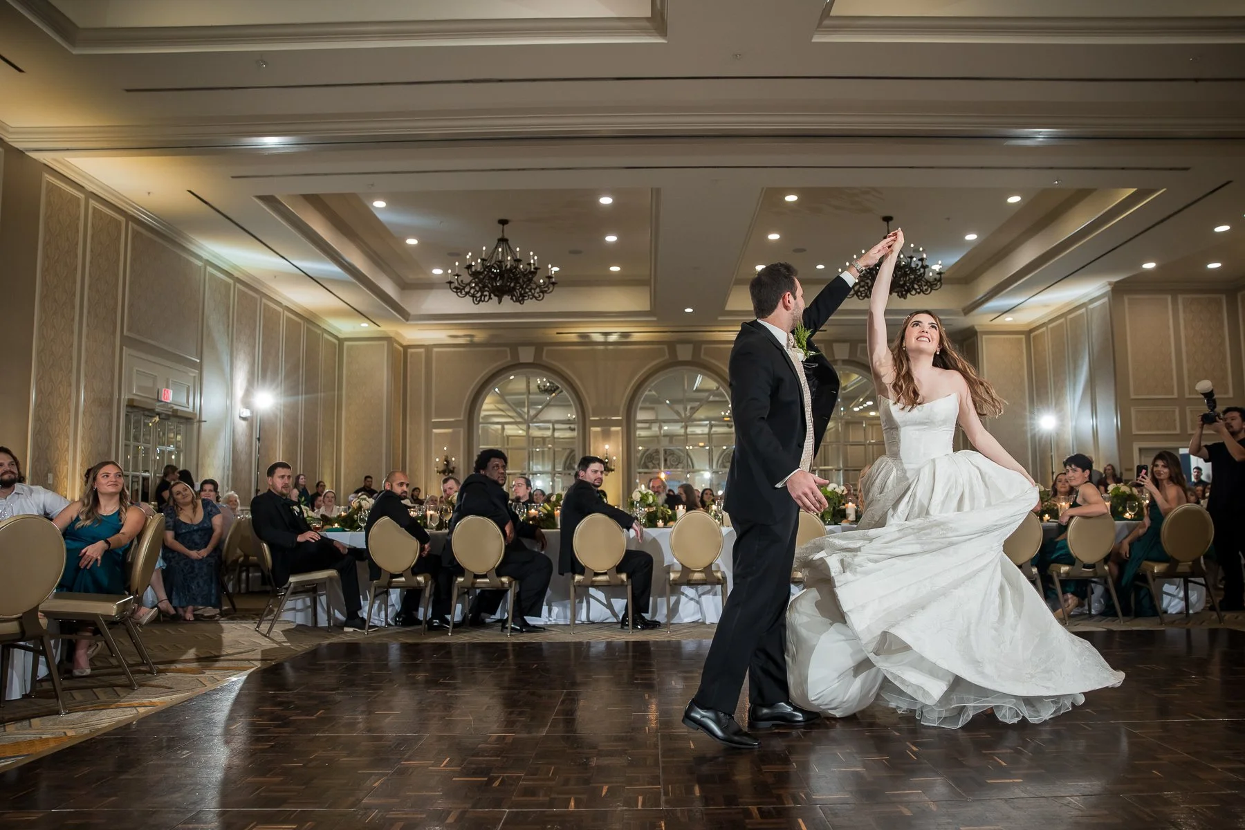 Bride and groom sharing their first dance during a wedding reception at The Adolphus Hotel in Dallas