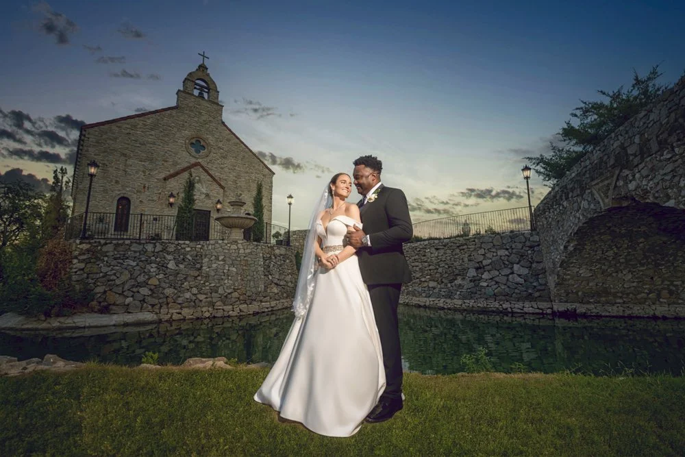Waterfront wedding portrait of Mallory and Marcus beneath a darker sky.
