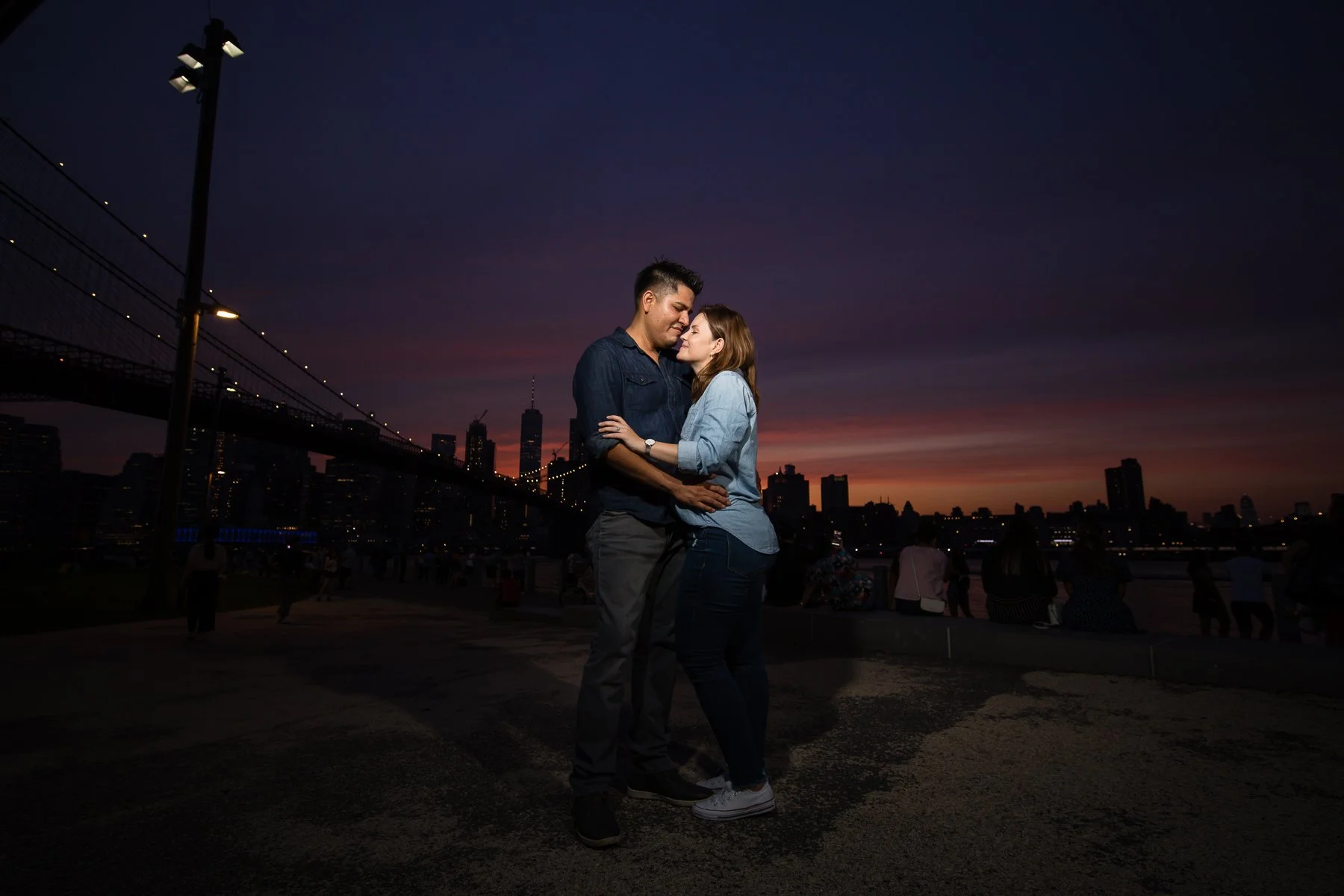 Newly engaged couple photographed at sunset after their surprise proposal
