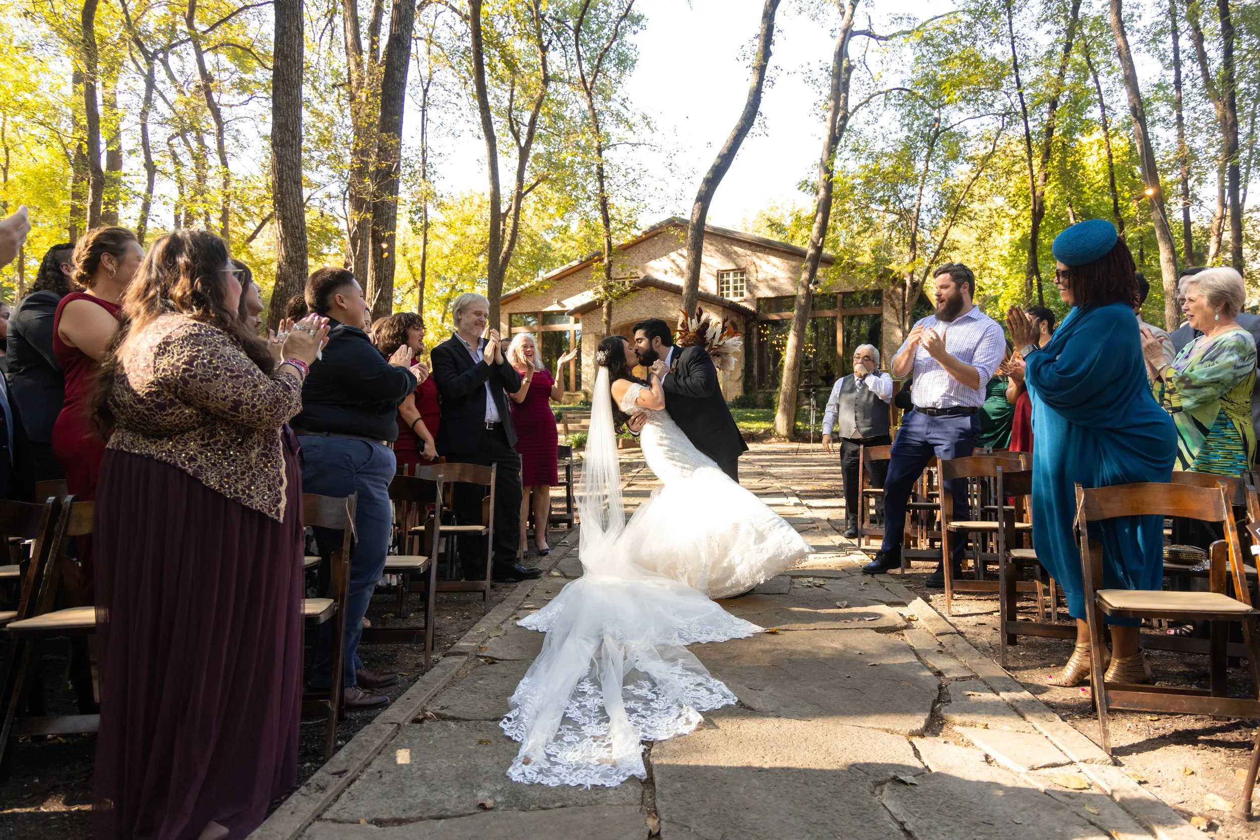 Bride and groom celebrating during an outdoor wedding ceremony surrounded by guests in Dallas–Fort Worth