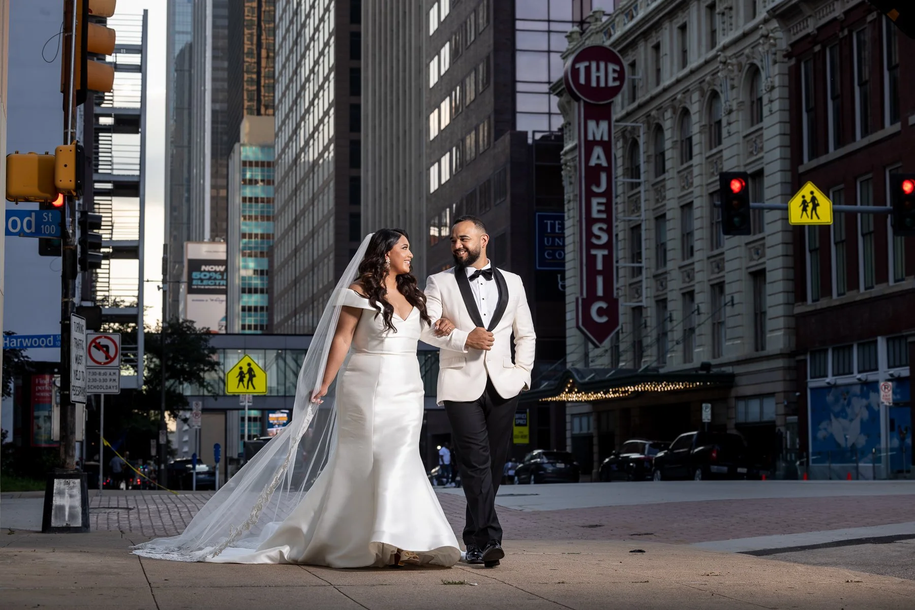 Bride and groom walking through downtown Dallas during their Hall on Dragon wedding portraits