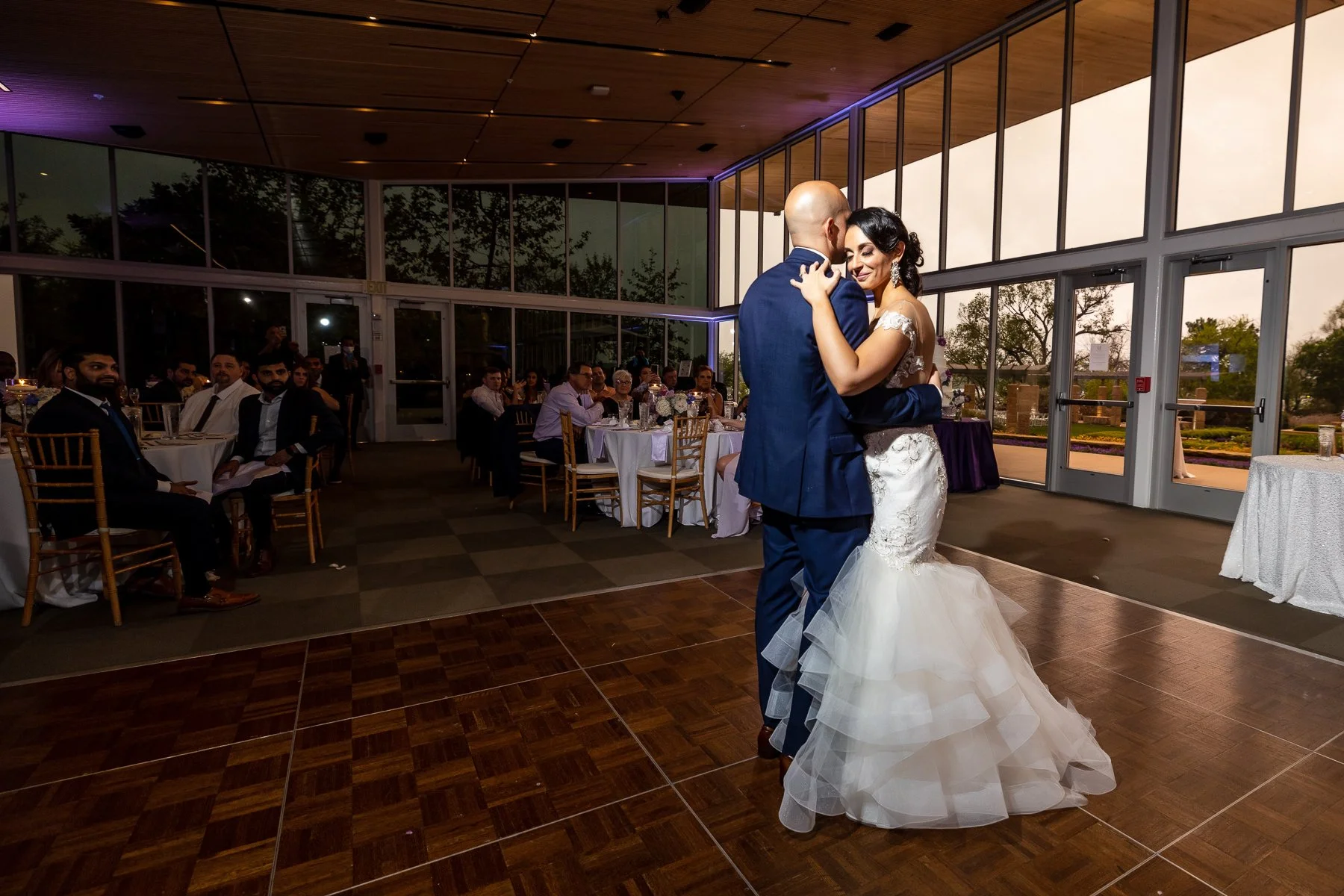 Bride and groom sharing their first dance during a Dallas Arboretum wedding reception in Dallas.