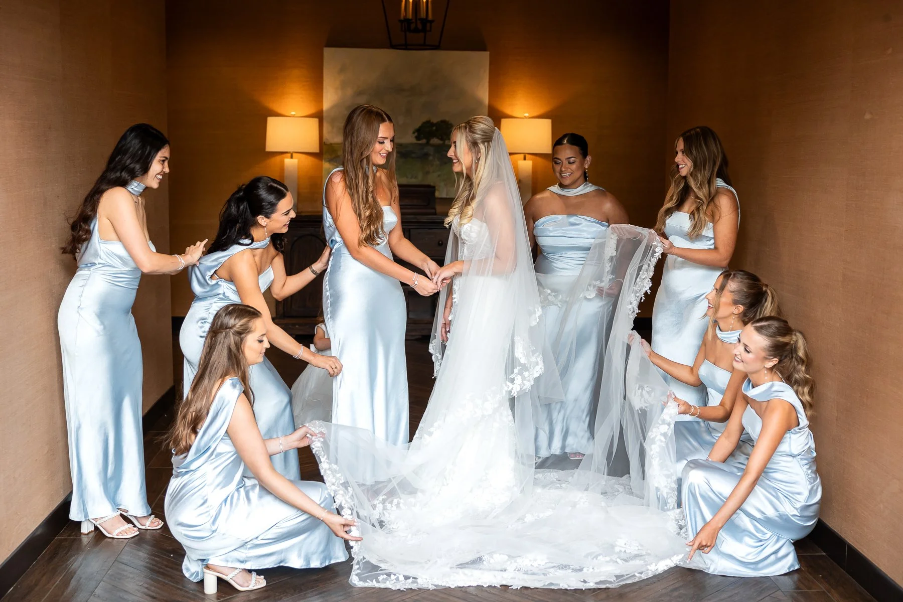 Bride surrounded by bridesmaids inside The Laurel wedding venue.