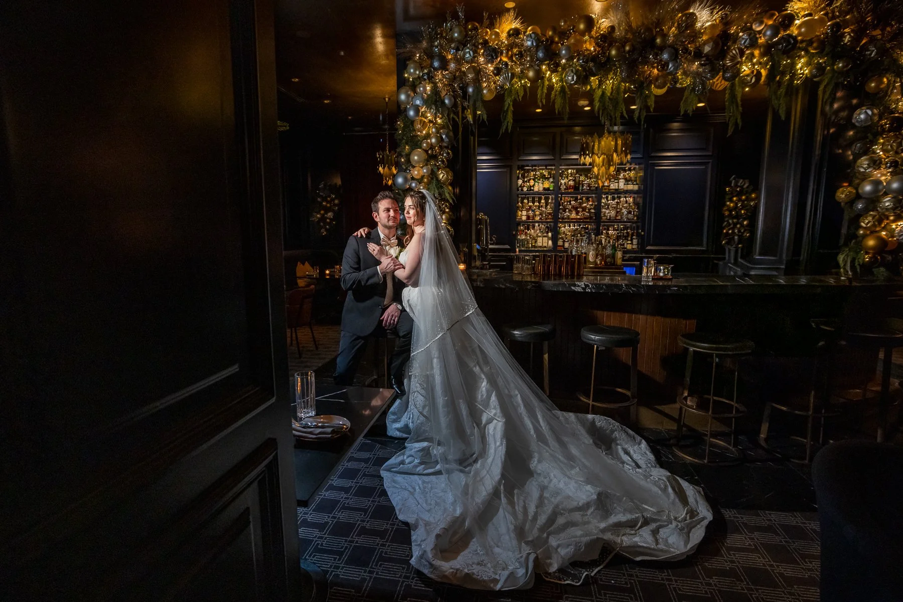 Bride and groom photographed inside a dark lounge at The Adolphus Hotel in Dallas