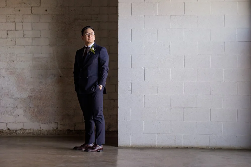 Groom portrait against the industrial brick wall at 4Eleven in Fort Worth, Texas