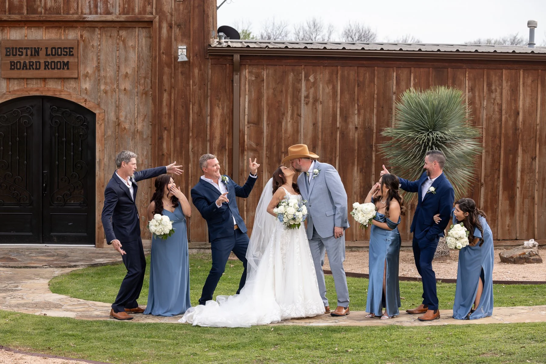 Bride and groom with their wedding party at Lucky Spur Ranch in Justin, TX.